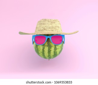 Summer times of funny attractive watermelon in stylish sunglasses with hat on pink background. minimal fruit concept. Creative idea foods and drinks that are typically enjoyed at summer festivals 