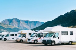 Summer Tourism With RV In The Mountain. Campers Parked In A Row In A Caravan Parking Area. Best Option For Travel. Motorhomes And Campingcar.