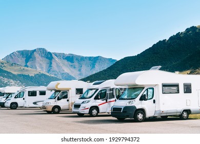 Summer tourism with RV in the mountain. Campers parked in a row in a caravan parking area. Best option for travel. Motorhomes and campingcar. - Shutterstock ID 1929794372