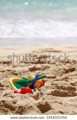 Similar – Sandstrand mit Spiezeugschaufel und Seestern