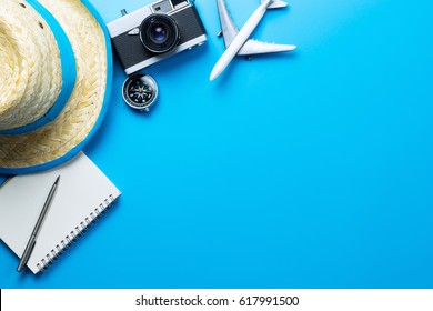 Summer Travel accessories and objects on blue background copy space, For Beach Vacation Journey with plane camera notebook, For Travel poster and banner advertisement - Shutterstock ID 617991500
