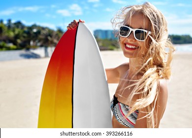 Summer Travel Beach Vacation. Close Up Of Healthy Happy Beautiful Sexy Woman In Sunglasses With Surfboard Having Fun By Sea. Active Lifestyle. Leisure Sporting Activity. Water Sports. Summertime Relax