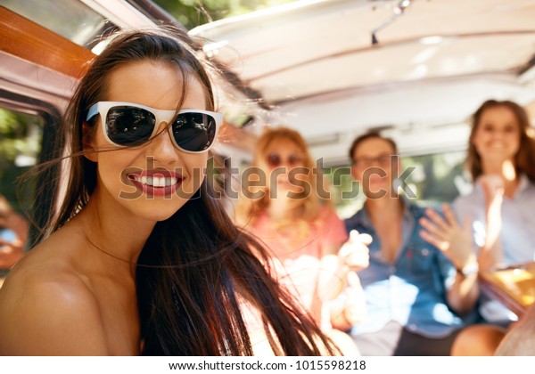 Summer\
Travel. Happy Woman Having Fun WIth Friends In Car. Portrait Of\
Happy Smiling Girl In Stylish Sunglasses Traveling In Retro Hippie\
Bus, Enjoying Trip On Weekend. High Quality\
Image