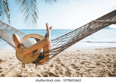 Summer travel vacation concept, Happy traveler asian woman with white bikini relax in hammock on beach in Koh mak, Thailand - Shutterstock ID 1978655663