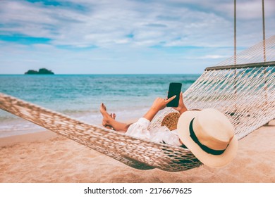 Summer travel vacation concept, Happy traveler asian woman using mobile phone and relax in hammock on beach in Koh Chang, Trad, Thailand - Shutterstock ID 2176679625