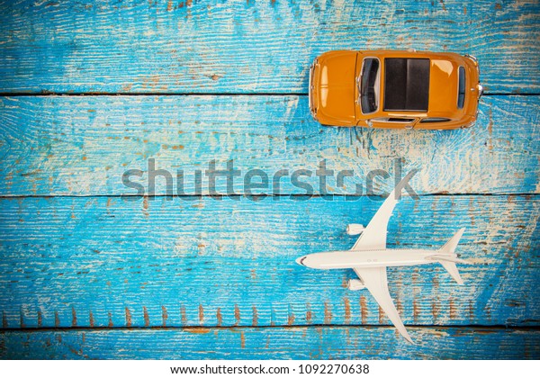 Summer traveling time. Sea holiday\
background with car and airplane. Place for your\
text.