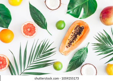 Summer tropical composition. Green palm leaves and tropical fruits on gray background. Summer concept. Flat lay, top view - Powered by Shutterstock