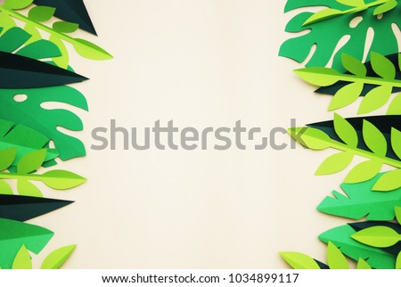 Summer Tropical Paper Cut leaves, Frame. Exotic summertime. Space for text. Beautiful dark green jungle floral background. Monstera.