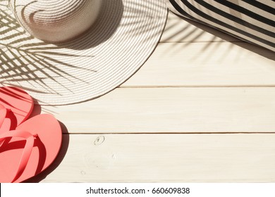 Summer Vacation Background Of Straw Hat, Beach Bag, Pink Flip Flops And Palm Leaves Shadow. Vacation, Holiday, Travel, Tourism Concept. Top View.