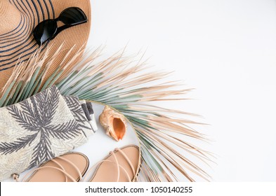 Summer Vacation Background. Top View Of Straw Hat, Green Palm Leaf ,ocean Shell, Beach Towel, Sunglasses And  Sandals. Flat Lay Beach Accessories. Concept For Summer Times And Travel. 