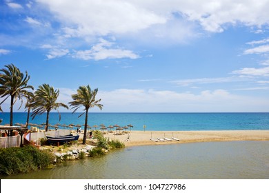 Summer vacation beach and sea scenery on Costa del Sol in Spain, located between Marbella and Puerto Banus, waters of Green River (Spanish: Rio Verde) and Mediterranean Sea.