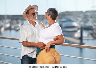 Summer Vacation Bliss. Happy Senior Family Couple Enjoys Summer At Marina Dock Outdoor, Hugging In Front Of Elegant Yachts, Posing With Straw Hats And Sunglasses. Joy Of Seaside Holidays - Shutterstock ID 2310519183