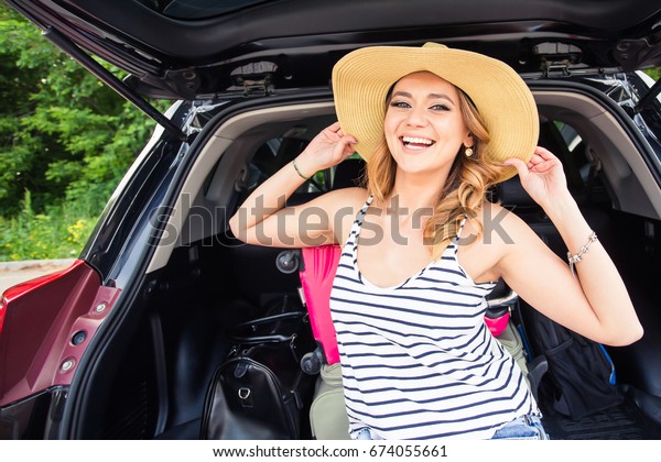 Summer vacation car road trip
freedom. Happy woman cheering joyful during holiday travel with
car.