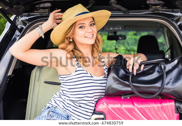 Summer vacation car road\
trip freedom concept. Happy woman cheering joyful during holiday\
travel with car.