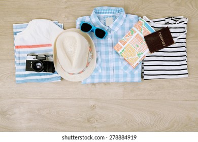 Summer Vacation Clothes, Shoes And Hat On Wooden Background