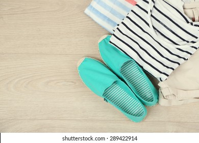 Summer Vacation Clothes, Shoes And Hat On Wooden Background