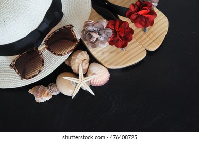 Summer vacation concept, hat, seashells and sunglasses on black grunge background - Shutterstock ID 476408725