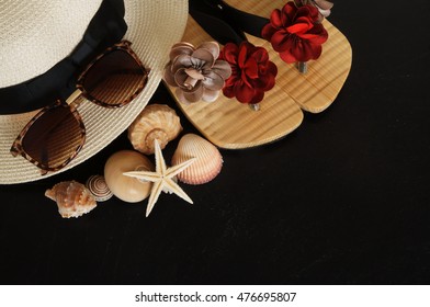 Summer vacation concept, hat, seashells and sunglasses on black grunge background - Shutterstock ID 476695807