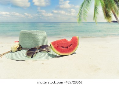 Summer Vacation Concept Straw Hat With Sunglasses And Melon Fruit On Sandy Tropical Beach