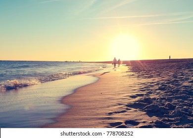 Summer Vacation. Couple Walking On Tropical On The Beach At Sunset In Vintage Color