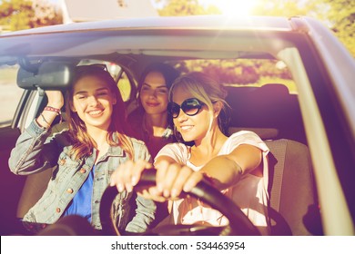 Summer Vacation, Holidays, Travel, Road Trip And People Concept - Happy Teenage Girls Or Young Women Driving In Car