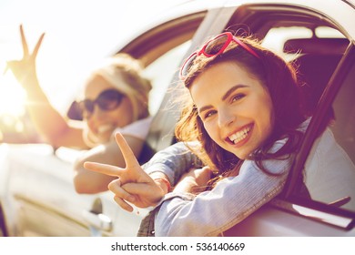 Summer Vacation, Holidays, Travel, Road Trip And People Concept - Happy Teenage Girls Or Young Women In Car At Seaside