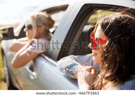 Similar – Two young women resting sitting inside of car