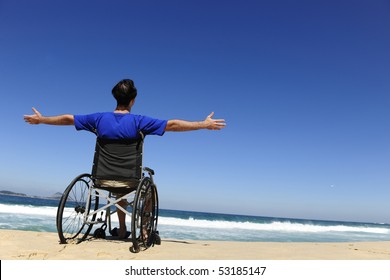 summer vacation: man in wheelchair enjoying outdoors beach - Powered by Shutterstock