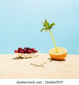 Summer Vacation  Scene Of Tropical Fresh Fruit. Orange With Drinking Straw And Mint Leaf . Paper Boat With Ripe Cherries. Minimal Juicy Food Concept.