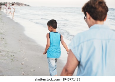 Summer Vacation At Sea. Boy And Senior Woman At Seaside. Grandmother With Grandchild Are Resting On Sea, Running On Beach Having Fun At Summer Holiday. Active Parents, People Activity With Children.