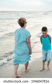 Summer Vacation At Sea. Boy And Senior Woman At Seaside. Grandmother With Grandchild Are Resting On Sea, Running On Beach Having Fun At Summer Holiday. Active Parents, People Activity With Children.