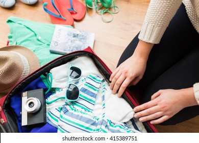 Summer Vacation, Travel, Tourism And Objects Concept - Close Up Of Woman Packing Travel Bag For Vacation