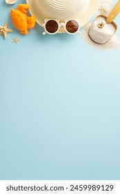 A summer vacation vertical setup with a straw hat, white sunglasses, sandy shovel, and starfish on a pastel blue background, capturing the essence of beach holidays