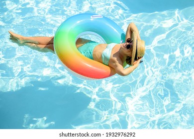 Summer Vacation. Woman in swimsuit on inflatable circle in the swimming pool