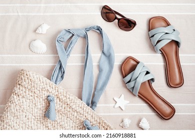 Summer vacations flat lay with beach accessories. Slippers, sunscreen, seashells over beach towel background Travel, tourism concept. Top view - Powered by Shutterstock