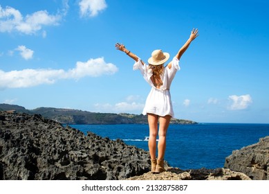 Summer vacations Lifestyle  happy woman relax and chill on beach. and holding hat in summer trips enjoy tropical beach. Lifestyle and Travel Concept.