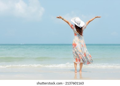 Summer Vacations. Lifestyle Woman Relax And Chill On Beach Background.  Asia Happy Young People With White Dress Raise Arm On The Wave Sea, Summer Trips Walking Enjoy  Tropical Beach. Lifestyle Travel