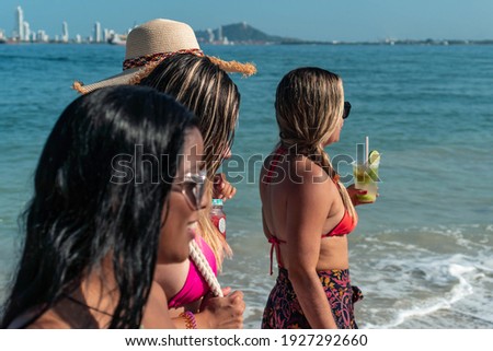 Summer vacations, vacation, vacation, travel and people concept - group of smiling young people with sunglasses and casual clothes walking on the beach.