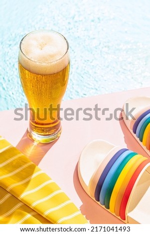 Summer vibes. Glass of cold frothy light beer over summer blue sky background. Vacation, happiness, drinks, beach, travel, fest and ad concept. Retro style. Bright hot day and cold drinks