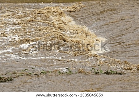 Summer view of torrent and muddy water of flood on rainy season at Yongamcheon Stream of Byeollae-dong near Namyangju-si, South Korea
