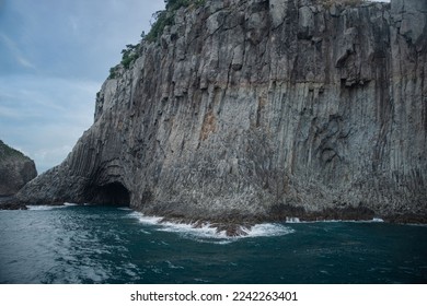 Summer view of wave on seaside rock and cliffs with columnar joint and cave at Munseom Island near Seogwipo-si, Jeju-do, South Korea
 - Powered by Shutterstock