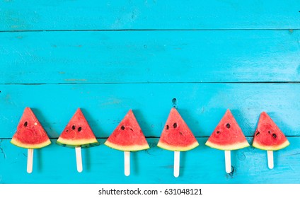 Summer Watermelon Slice Popsicles On A Blue Rustic Wood Background. Copy Space For Designer