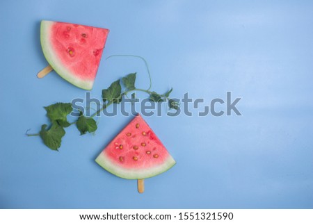 summer watermelon slice popsicles on blue  background