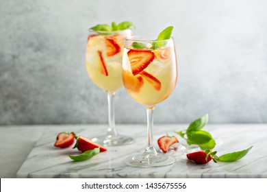 Summer white sangria with strawberries and basil