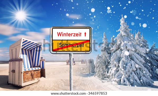 summer and winter\
changing season, weather concept with snow and beach, sign with\
text wintertime /\
summertime