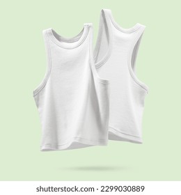 Summer Women's Clothing. Pair Ribbed white tank top flying on light green background. Female comfortable natural cotton cloth. Creative template for design Mock up. Copy space.