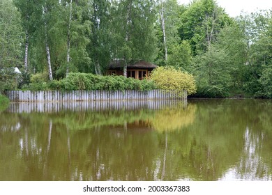 Summer Wooden Lake House Inside Forest . High Quality Photo