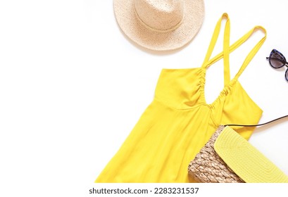 Summer yellow dress with straw hat, beach bag and sunglasses on the white background. Top view. Copy space - Powered by Shutterstock