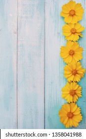 Summer yellow flowers on a light wooden background. Bright summer floral background with space for text. Colorful flower card. - Shutterstock ID 1358041988