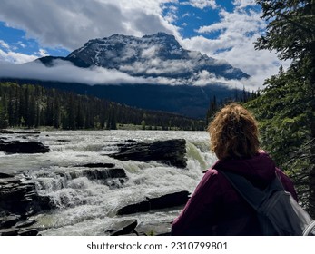 Summer and young woman in Athabasca Falls, Jasper National Park, Canadan rockies
